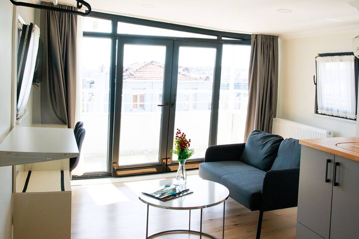 A modern living room with a sofa, a coffee table, and a television.