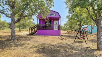 Guests can relax on the porch or enjoy the surrounding natural landscape.