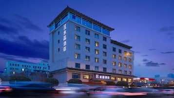 A multi-story hotel with a prominent sign on the building.