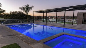 A rectangular swimming pool with a glass enclosure and a separate section with a blue light. - La Cascada Hotel Boutique (Juanacatlán)