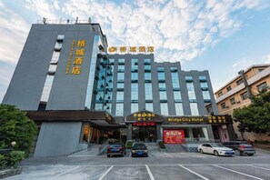 A hotel with a modern facade, multiple floors, and a prominent entrance. - Qiao Cheng Hotel (Duyun)