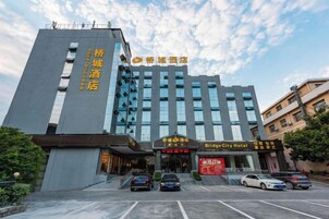A hotel with a modern facade, multiple floors, and a prominent entrance.