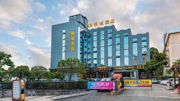 A hotel with multiple floors, a prominent entrance, and signage indicating it is a city hotel.
