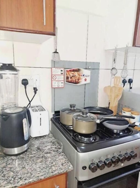 Enjoy cooking in this well-equipped kitchen with a gas stove, electric kettles, toaster, and blender.