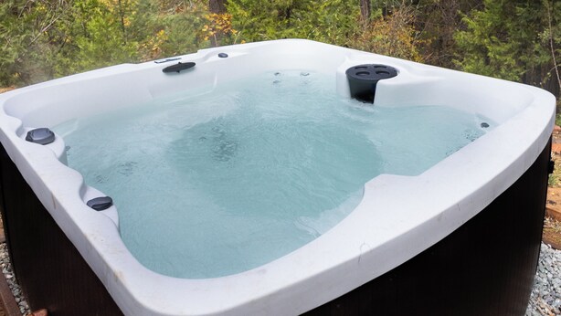 A hot tub in a forested area.