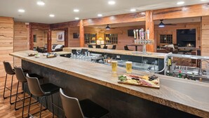 A bar area with a long counter, stools, and a variety of food and drink items. - EML 7 Cloven-Hoofed (Paonia)