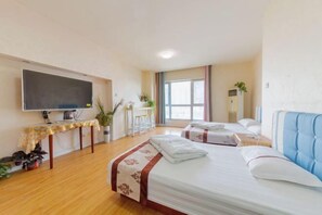 A hotel room with a bed, bedside tables, a TV, a desk, and a window. - Seascape Boutique International Apartment (Xi'an)
