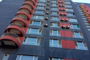 A multi-story building with balconies, air conditioning units, and a patterned facade. - Seascape Boutique International Apartment (Xi'an)