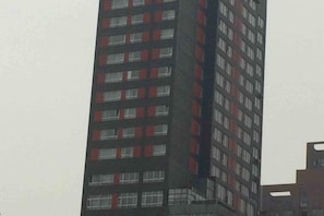 A tall building with multiple floors and a series of windows.