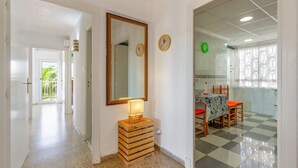 A hallway with a wooden crate, a mirror, and clocks on the wall. - Awesome apartment in Torrevieja with WiFi (Torrevieja)