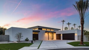 A modern two-story house with a garage, a driveway, and a well-maintained lawn. - Polo Villa Serenity 2 Homes Sleeps 34 13 BDR (La Quinta)