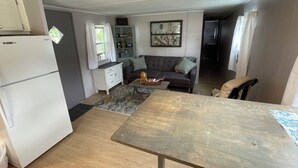 A compact living space with a kitchen, dining area, and seating area.