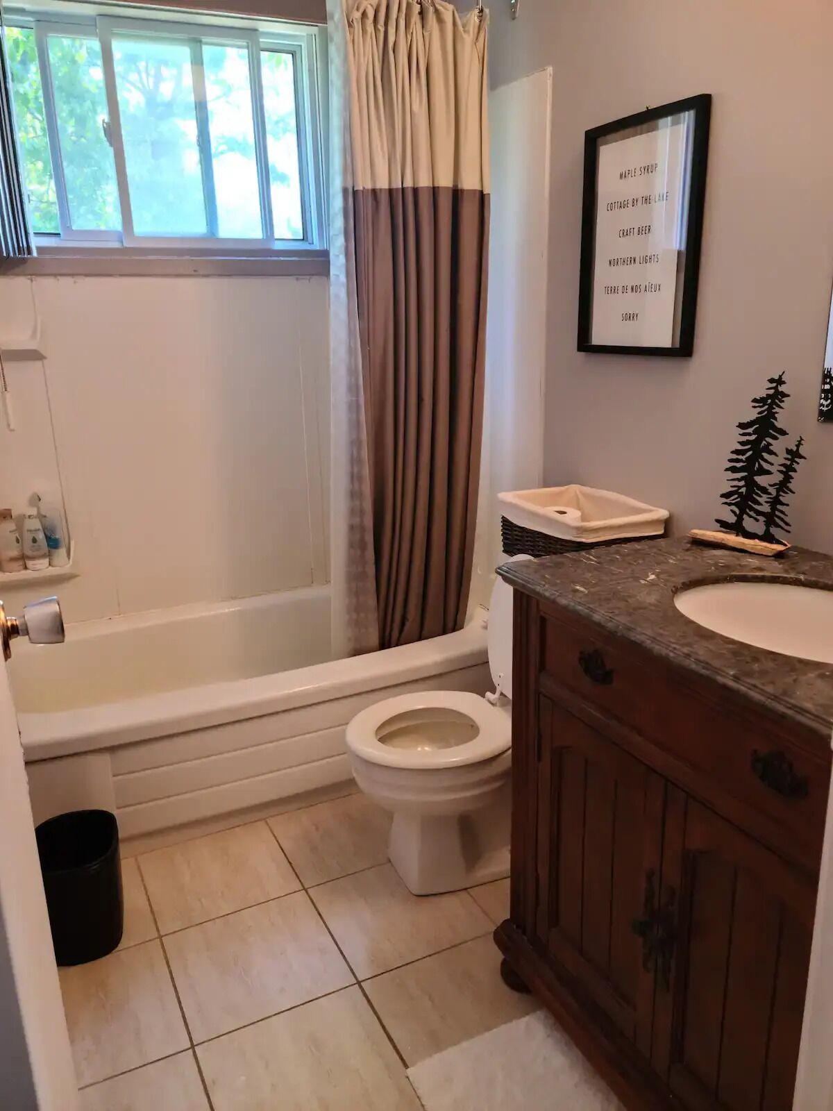 A bathroom with a bathtub, toilet, and vanity.