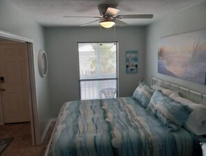 Cozy retreat with a single bed, ceiling fan, and window with blinds.