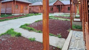 A wooden building with a covered porch and stone pathway. - Ushba Gate House (Mestia)