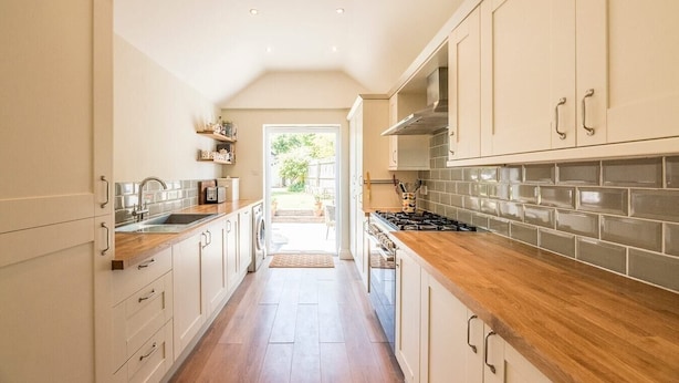 A modern kitchen with wooden countertops, stainless steel appliances, and light-colored cabinetry. - Olive Cottage, Wickham Market (Wickham Market)