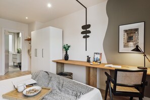 Relax in a thoughtfully designed space with a desk, sofa, and comfortable seating area.
