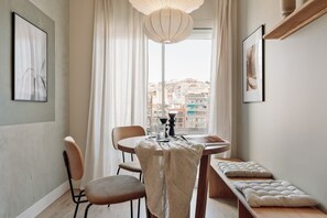 Enjoy a city view from the large window, with a dining table for two and a comfortable bench for extra seating.