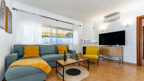 A living room with a sofa, coffee table, and TV. - Holiday Home 'Casa Cerro Del Aguila' with Mountain Views, Wi-Fi and Air Conditioning (CERROS DEL AGUILA)