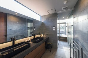 A modern bathroom with a large mirror, dual sinks, and a glass shower enclosure. - Morris Resort Tohginbow (Sakai)