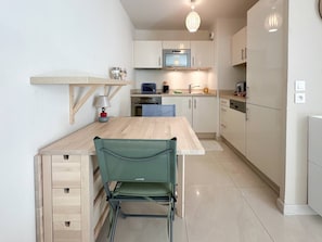 Fridge, dishwasher, coffee/tea maker, cookware/dishes/utensils