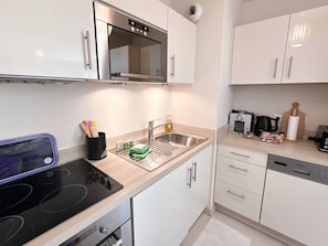 Fridge, dishwasher, coffee/tea maker, cookware/dishes/utensils