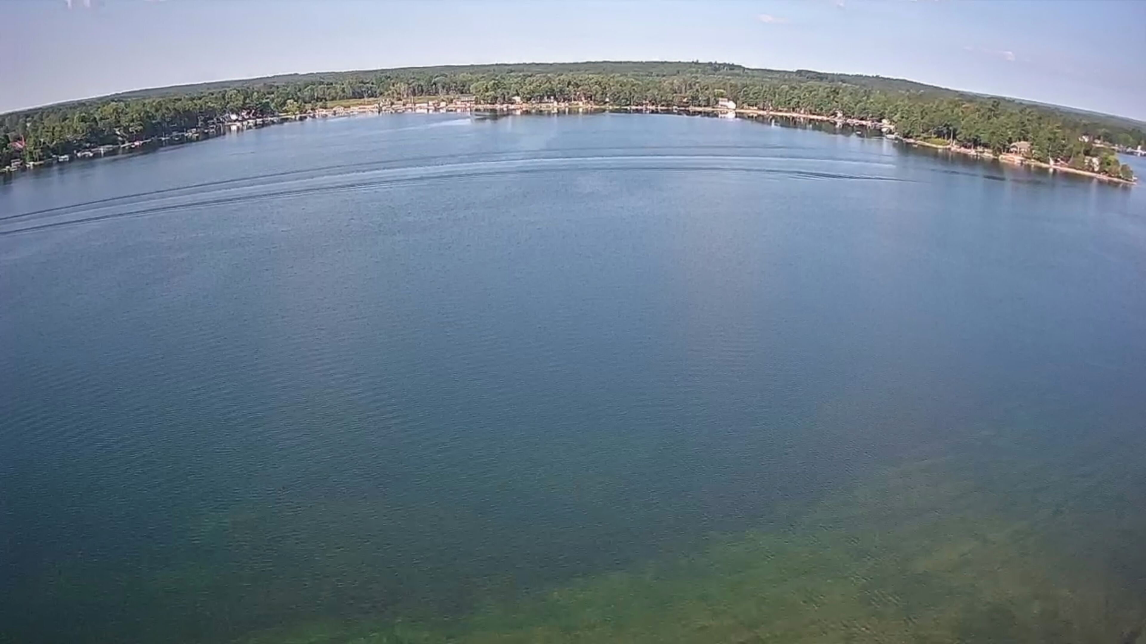 A large, calm body of water with a curved shoreline.