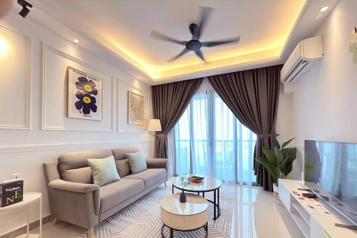 A modern living room with a sofa, coffee table, and TV.