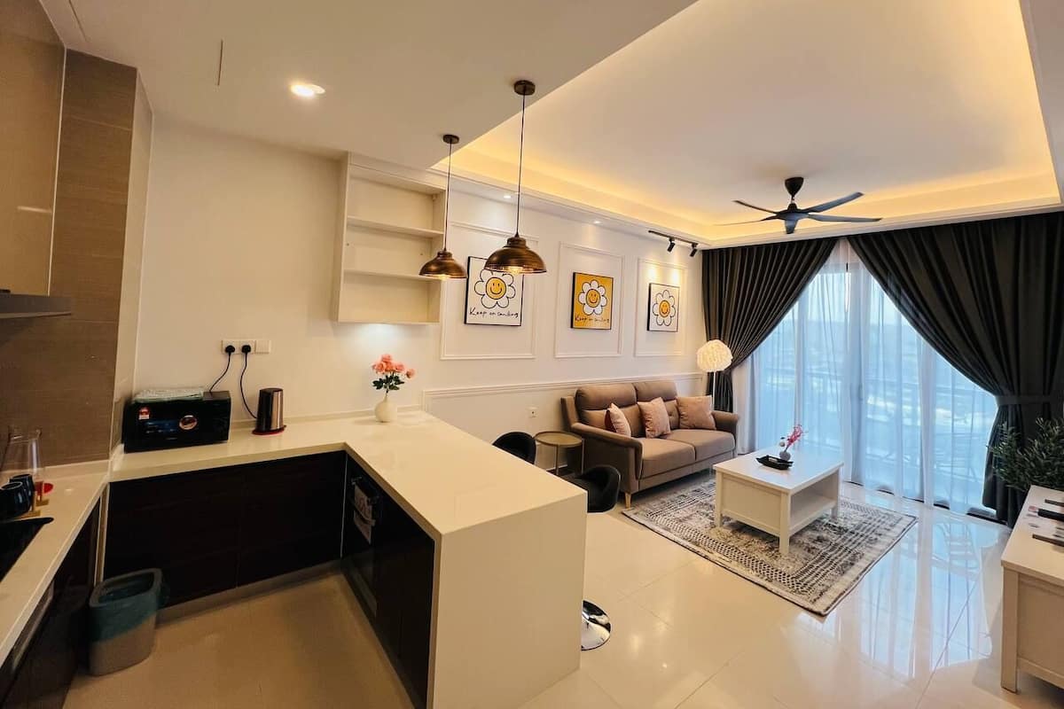 A modern living room with a sofa, coffee table, and artwork on the wall.