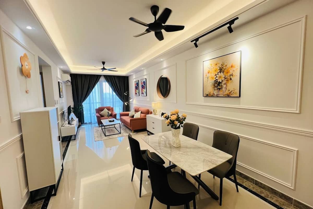 A modern dining area with a marble table, black chairs, and a ceiling fan.