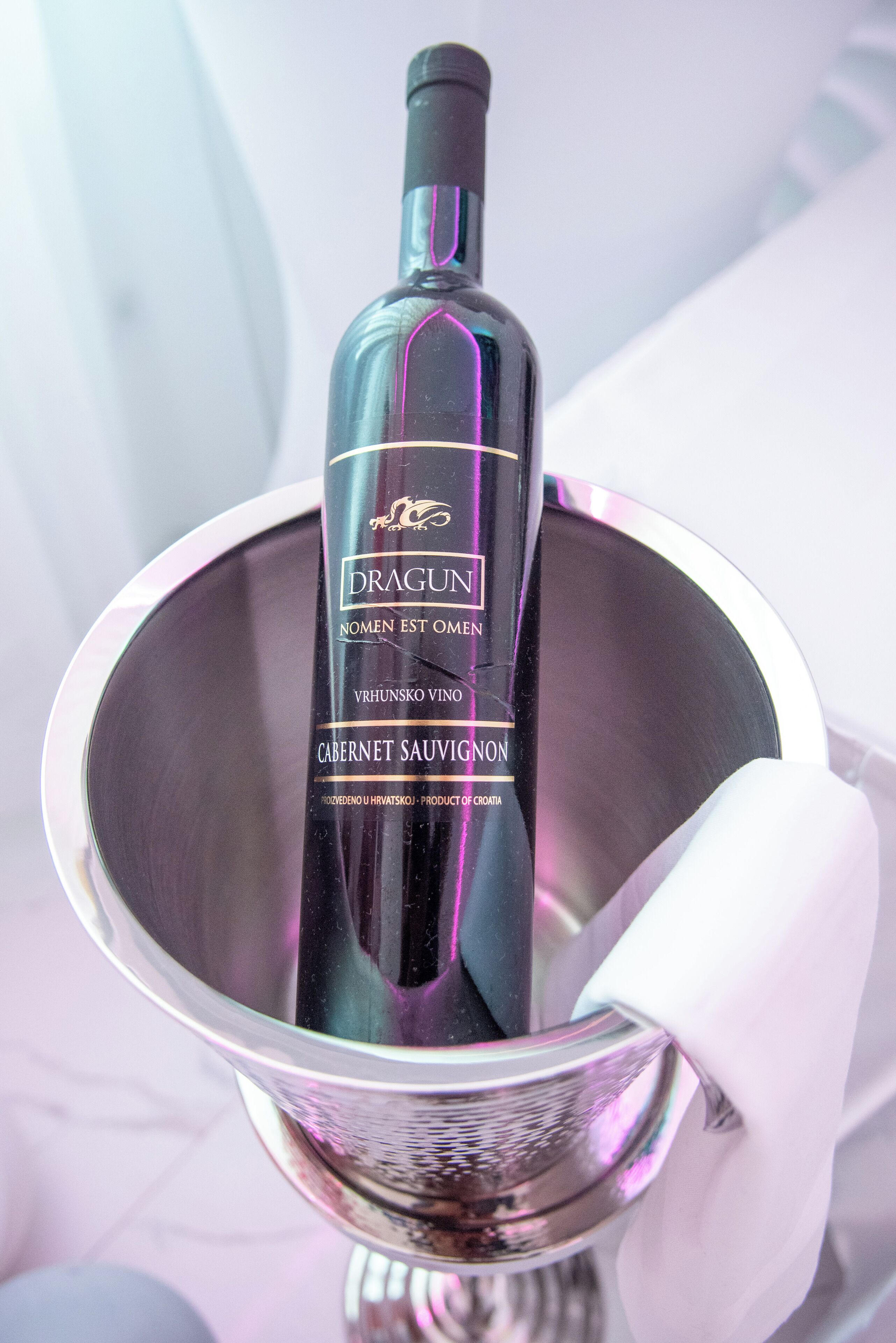 A bottle of Dragun Cabernet Sauvignon in a metallic bucket.