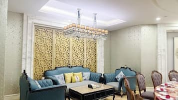 Una habitación con un conjunto de sofás, una mesa de centro y una mesa de comedor con sillas.