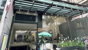 A modern building with a glass entrance, a sign indicating room number 382/27, and a visible staircase leading to an upper floor. - Home Away Minh Khai (Ho Chi Minh City)
