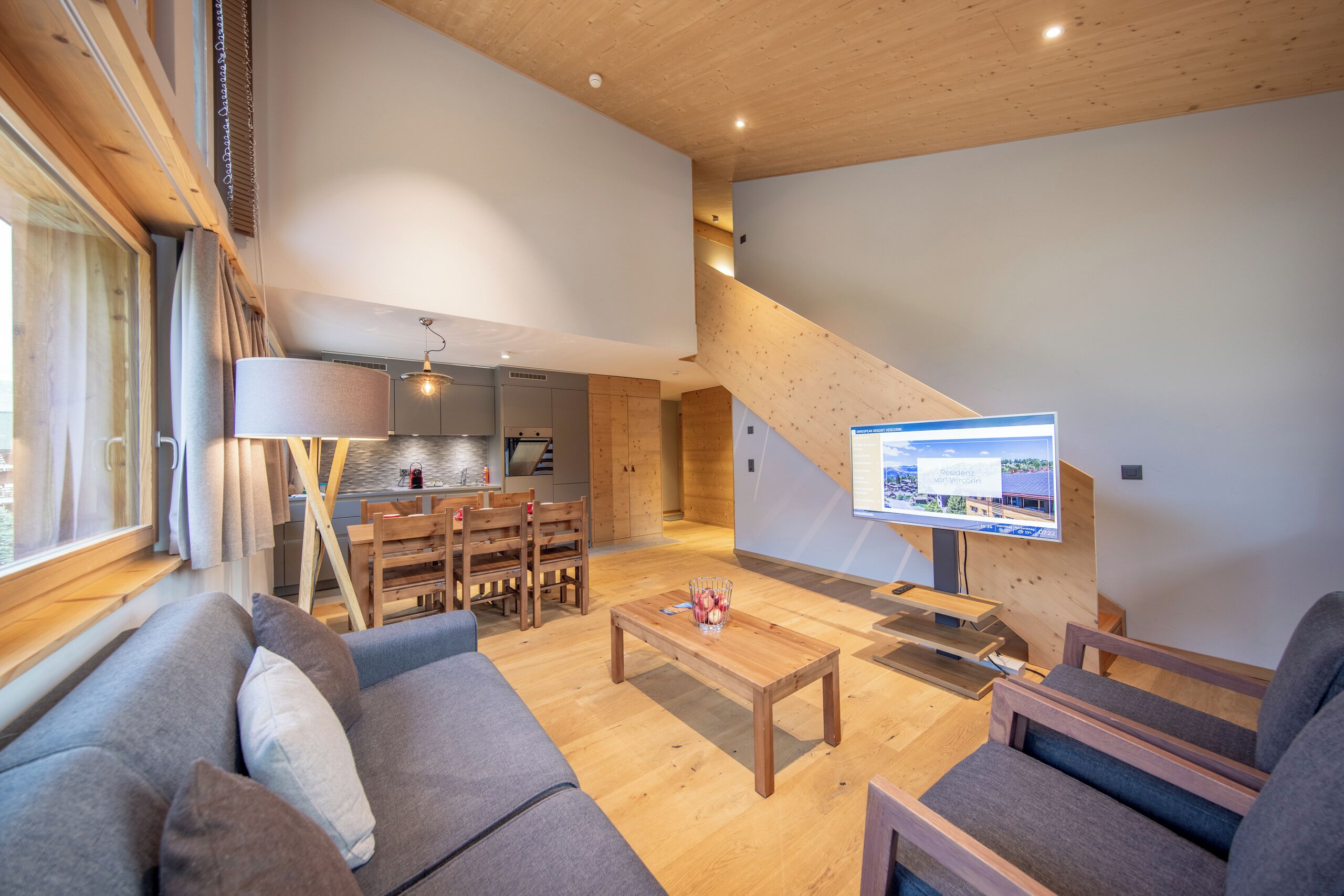 A modern living room with a sofa, coffee table, and TV.
