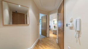 A hallway with wooden flooring, a mirror, and a telephone. -  Quayside Newcastle (Newcastle upon Tyne)