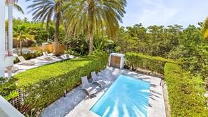 A swimming pool with lounge chairs, palm trees, and a small shed. - Villa 6p private pool   Orient Bay Beach (Community of Saint Martin)