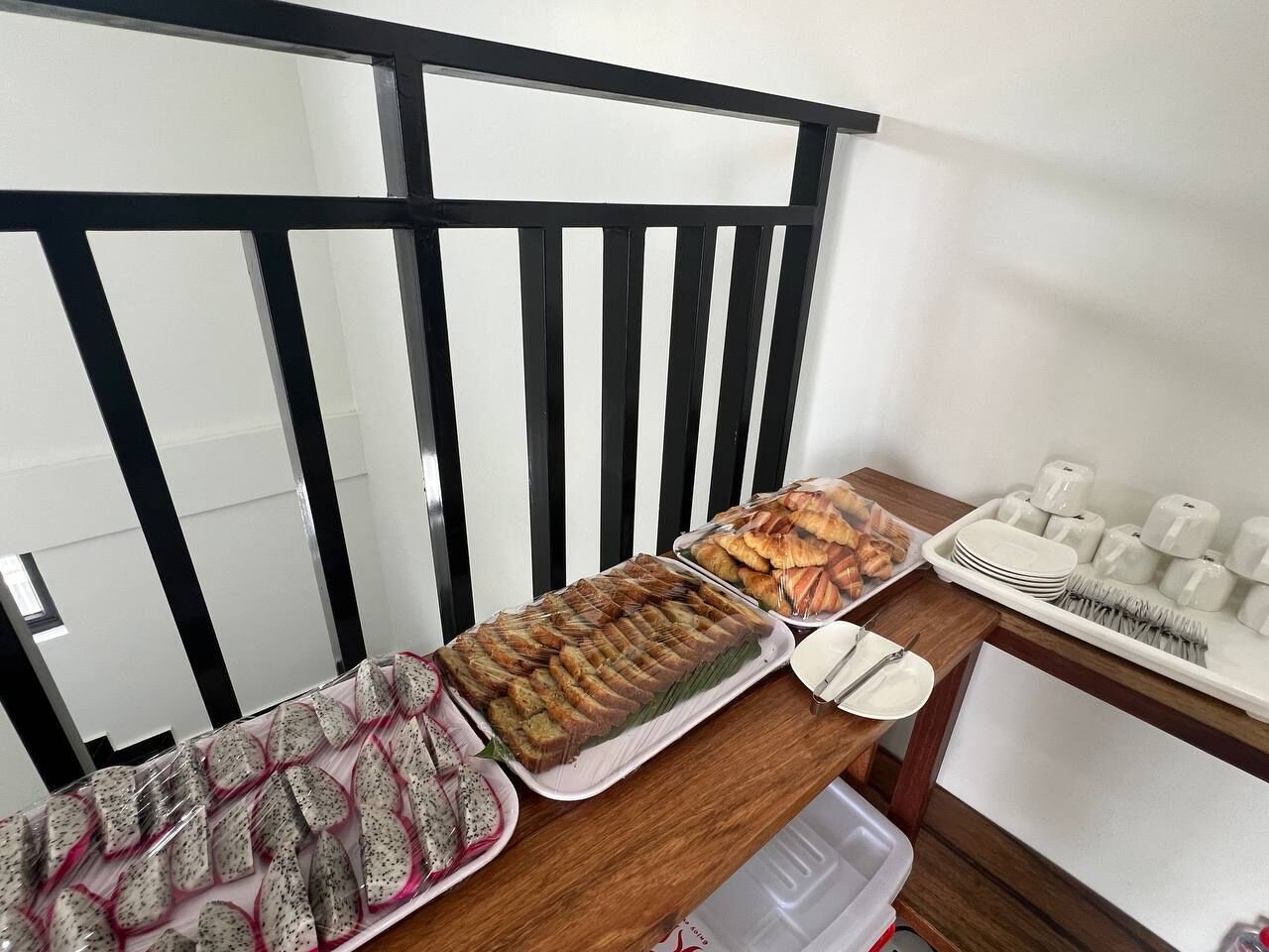 A buffet table with various food items and utensils.