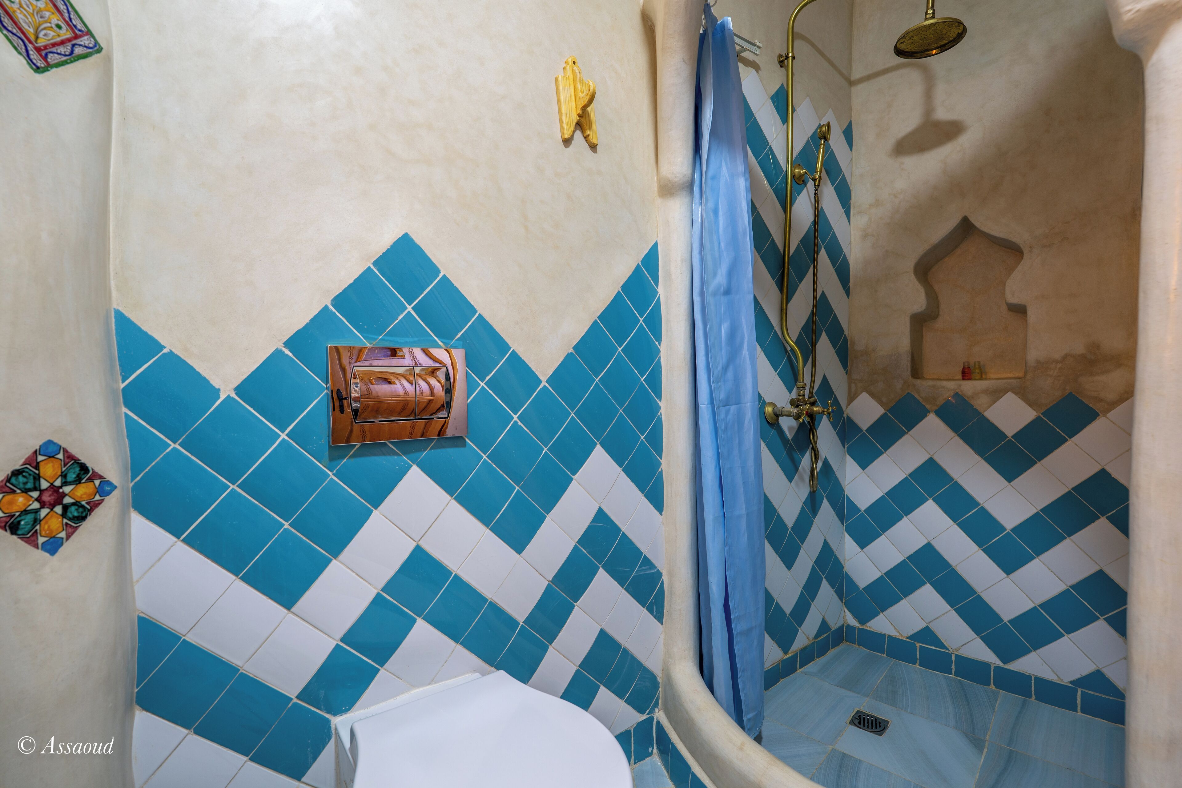 A bathroom with a shower, a toilet, and a sink.
