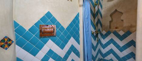 A bathroom with a shower, a toilet, and a sink.