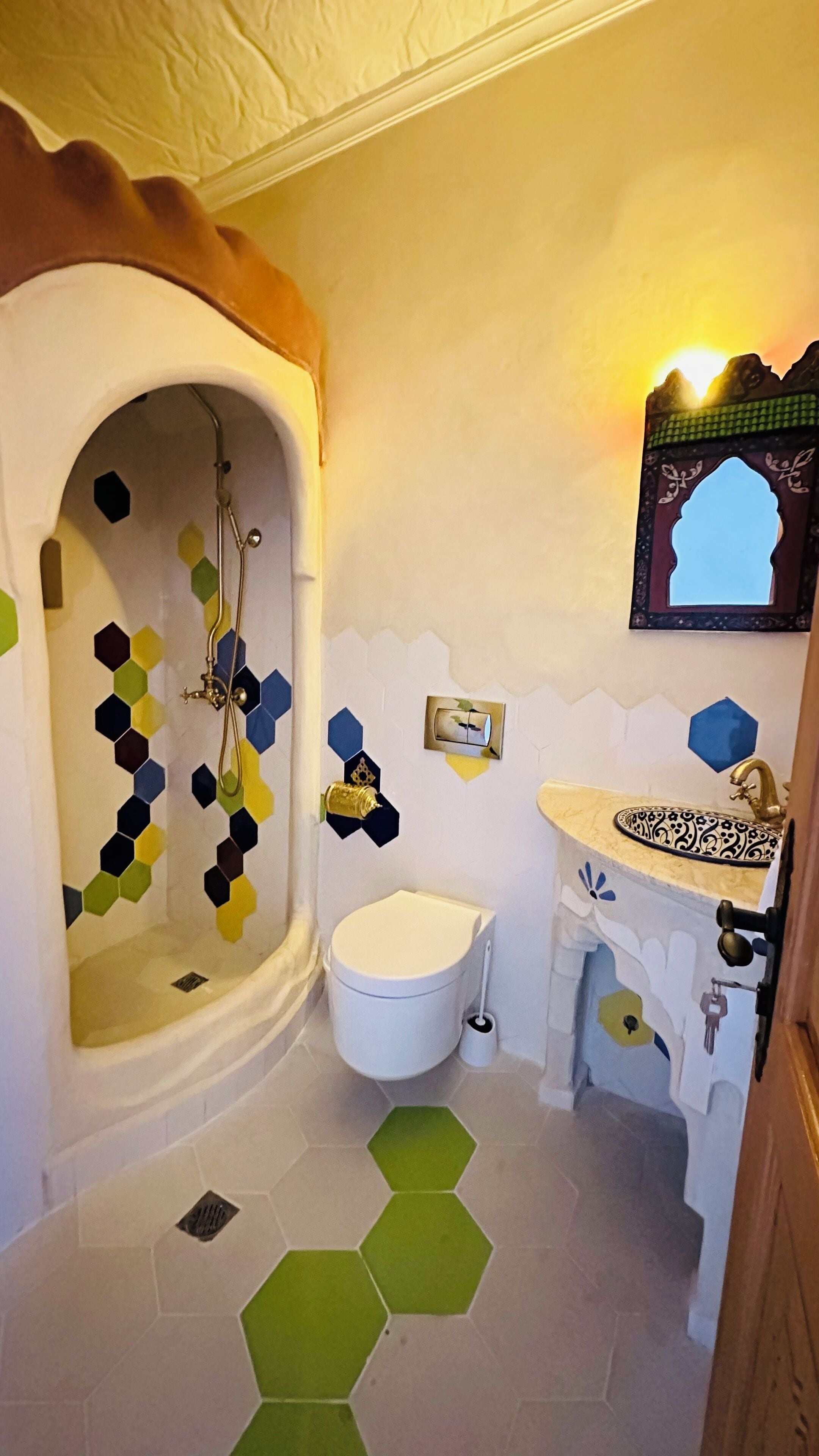 A bathroom with a shower, toilet, and sink.