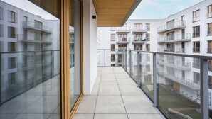 A modern residential building with balconies, large windows, and a clear sky. - Native Apartments Orawska 14 (Kraków)