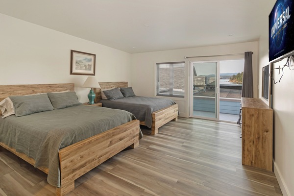Private two queen beds with full bathroom, smart TV, partial harbor view.
