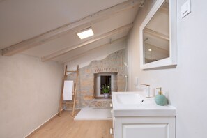 A bathroom with a stone wall, a white sink, and a wooden ladder. - Casa di Nika Stone Villa With Pool & Jacuzzi (Vinodol)