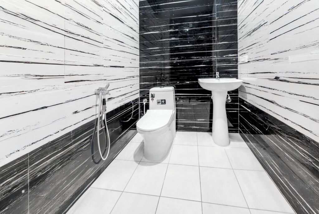 A bathroom with a toilet, bidet, and sink.