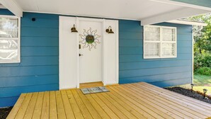 A blue house with a white door, a wooden deck, and a welcome mat. - Middle Tennessee Cottage ~ 10 Mi to Dickson! (Bon Aqua)