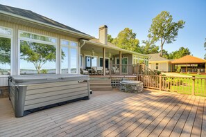 A deck with a hot tub, outdoor seating, and a covered area with a railing. - Lakefront Gem: Hot Tub, Boat Launch Near Greenwood (Cross Hill)