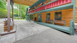 A log cabin with a covered porch and a second-story balcony with red railings. - 6 Mi to Town: Robbinsville Apt w/ Deck & Grill (Robbinsville)