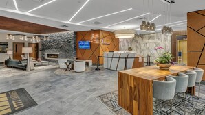 A modern lobby with a reception desk, seating area, and a fireplace. - Prime location Downtown Denver Cozy 2-bedroom condo in peaceful Denver (Denver)