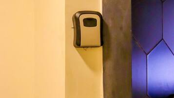 A wall-mounted soap dispenser and a light switch.