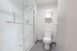A modern bathroom with a glass shower enclosure, a toilet, and a towel rack. - Hampton Inn Santa Clarita-valencia (Valencia)